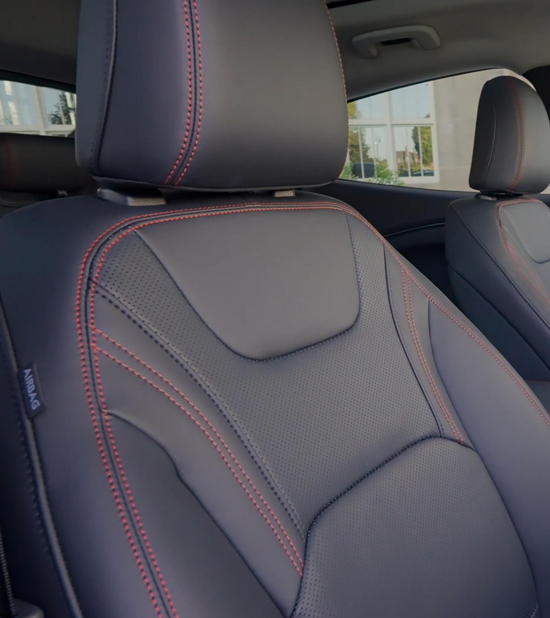 2025 Ford Mustang Mach-E® Premium model seats with red accent stitching and ActiveX® material